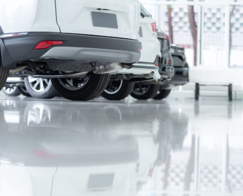 Showroom with cars on durable white, reflective epoxy flooring in Philadelphia, PA.